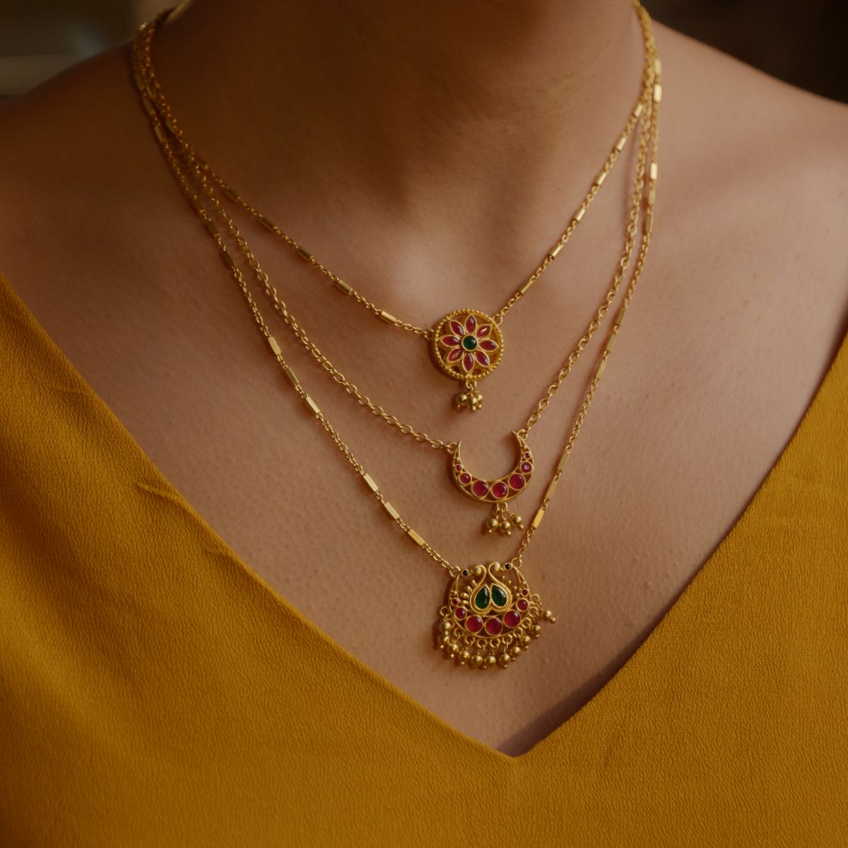 Moon and Blooms layered necklace worn with festive gold clothing